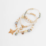 Set de pulseras doradas con dije mariposa