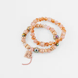 Set de pulseras nude con cuentas y dije corazón